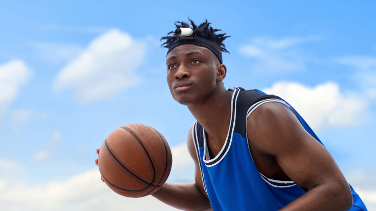 insta360 go 3s mounted on a guy's headband in the pivot stand while he plays basketball